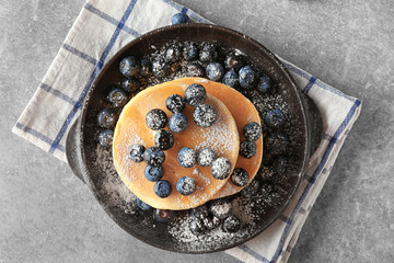 Delicious pancakes with berries on light table