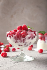 Tasty raspberry dessert on table