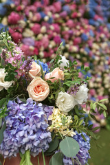 Flowered wedding wall. Decor with color hydrangea and roses. Wedding wall for ceremony and photo.
