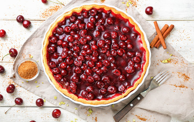 Tasty homemade cherry pie on white wooden table