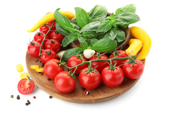 Plate with ripe cherry tomatoes, pepper, spices and herbs on white background