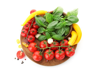 Plate with ripe cherry tomatoes, pepper, spices and herbs on white background