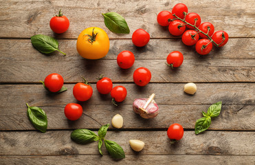 Fototapeta na wymiar Composition with ripe cherry tomatoes on wooden background