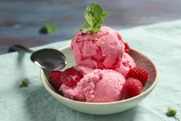 Bowl with delicious raspberry ice-cream on table
