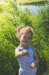 girl on a summer day fishing with a fishing rod