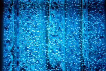 Clear transparent tube with bubble inside against abstract blue background