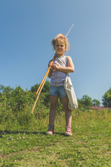 girl on a summer day fishing with a fishing rod