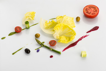 beautifully decorated pieces of tomato and asparagus on white background
