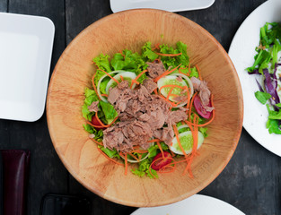 healthy Tuna in woodblow,tomato,cucumber,carrot,onion,Top view.