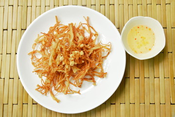 fried crispy needle mushroom on plate dipping sweet sauce