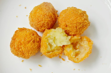 fried cheese ball cutting on white plate