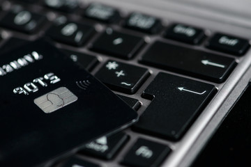 Credit card on the computer keyboard. Concept of online shopping