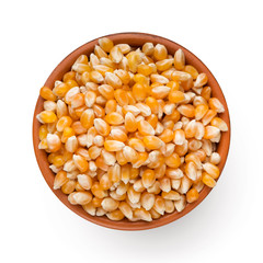 Dry corn in bowl on white background
