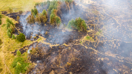 Aerial drone view of a smouldering wildfire in Wales, UK