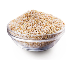 Bowl with barley grits isolated on white