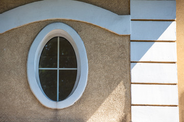 cozy oval window in the old wall