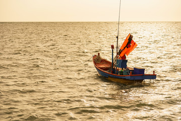 Floating fishing boats aground at the harbor in the sea sunset time at Chanthaburi, Thailand.