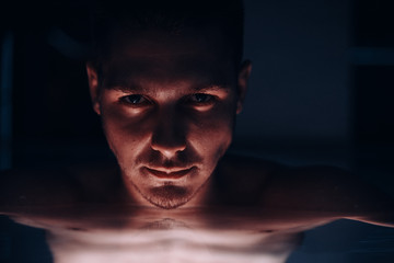 Male portrait.The guy in the pool.Guy posing in water