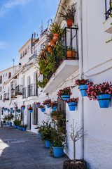 Fototapeta premium Beautiful view of old Mijas Calle Moro (Moro Street). Mijas (not far from Malaga) - Spanish hill town overlooking the Costa del Sol, known for its white-washed buildings. Mijas, Andalusia, Spain.