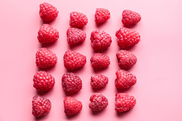 Sweet ripe raspberries on color background