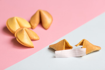 fortune cookie with blank page on pink and blue background, pastel colors