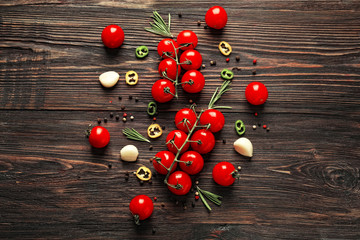 Composition with fresh cherry tomatoes on wooden background