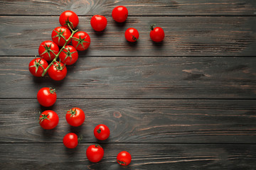 Fresh cherry tomatoes on wooden background