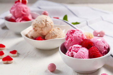 Bowls with delicious raspberry ice-cream on wooden table