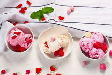 Bowls with delicious raspberry ice-cream on wooden table