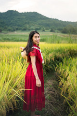 Girl in a rice field wearing red dress