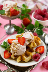 Belgian Liege waffles with strawberry ice cream and fresh berries