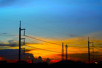 Fototapeta na wymiar silhouette of power electric line pillar and colorful sunset
