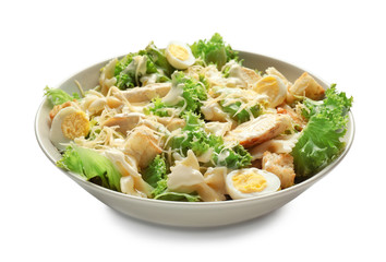 Tasty Caesar salad with pasta in bowl on white background