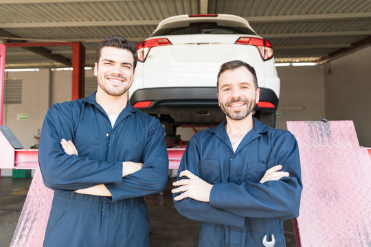 Automotive Workers Showing Contentment In Garage