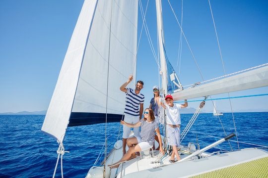 Family with adorable kids resting on yacht