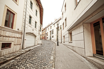 Fototapeta na wymiar Empty narrow cobblestone street in old town