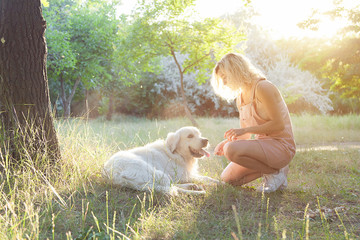 A pretty girl on a walk with a thoroughbred dog.