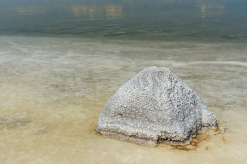 Stone with crystallized salt on Urmia Salt Lake. Iran