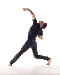 Young beautiful dancer is posing in studio