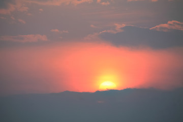 orange sun in the lilac sky during the sunset