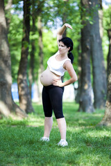 Young pregnant woman exercising