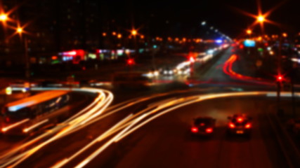 Fototapeta na wymiar blurred traffic light trails on road at night in Russia