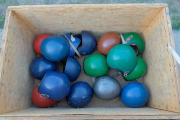 Many multi-colored helmets for parachuting in a storage box