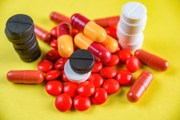 multi medical pills on a yellow background