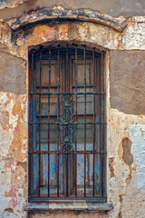 Fototapeta na wymiar old dusty window with rusty bars