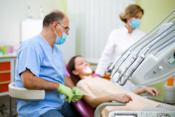 Dentist check up and repair tooth of young girl