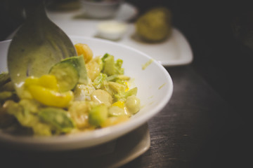 Close up image of a chef preparing a gourmet dish in a rustic restaurant kitchen