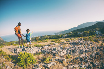 A woman is traveling with a child.