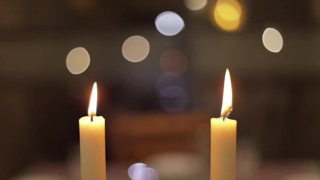 two candles lighting in slow mo