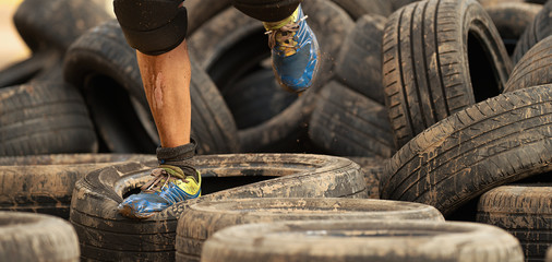 Mud race runners, tries to make it through the tire trap